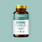Bio Schwarzkümmelöl Kapseln von Vitalplant im eleganten Glasbehälter auf mintgrünem Hintergrund